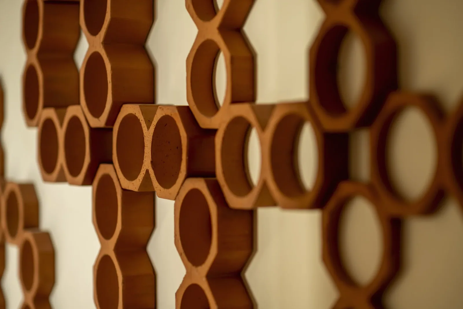 A detail of a carved wooden ring installation on an interior wall