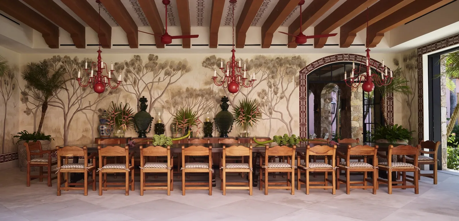 The dining pavilion&rsquo;s long table for twenty, under a hand-painted ceiling