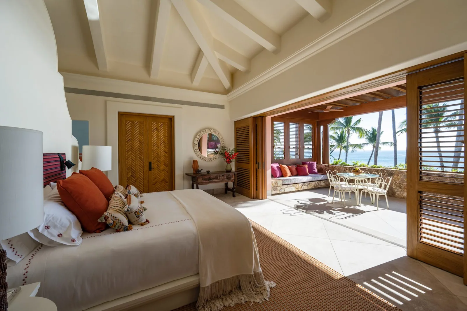 The principal apartment&rsquo;s bedroom, high-ceilinged and opening to its terrace