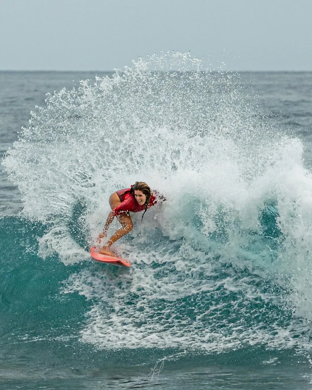 A surfer carving across a clean wave at one of the breaks near the estate