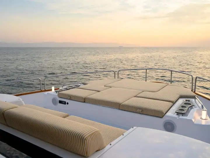 The day yacht&rsquo;s cushioned sun-pad bow, anchored on a calm sea
