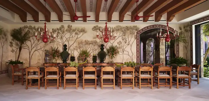 The dining pavilion&rsquo;s long table for twenty, under a hand-painted ceiling