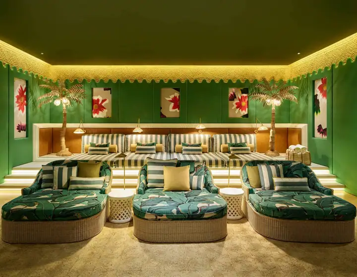 The private cinema&rsquo;s tiered daybeds, upholstered in green palm print