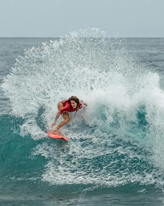 A surfer carving across a clean wave at one of the breaks near the estate